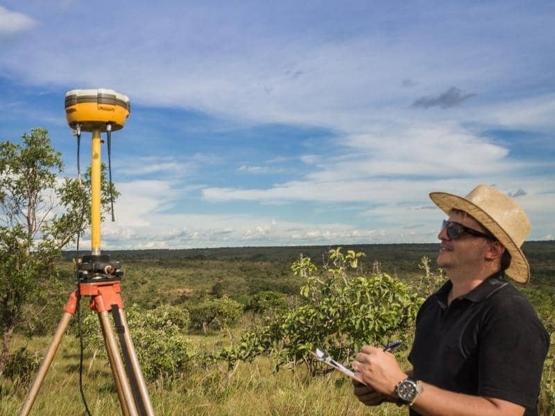 GPS surveyor mapping property lines and land features during a land survey project